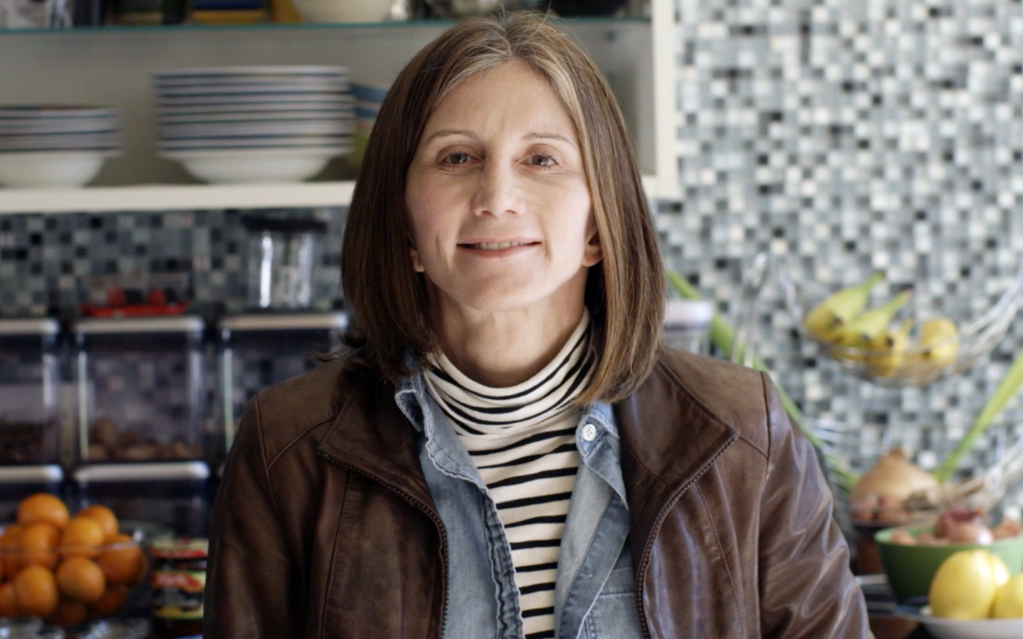 Nucleus recipient Sandy poses for a photo in her kitchen