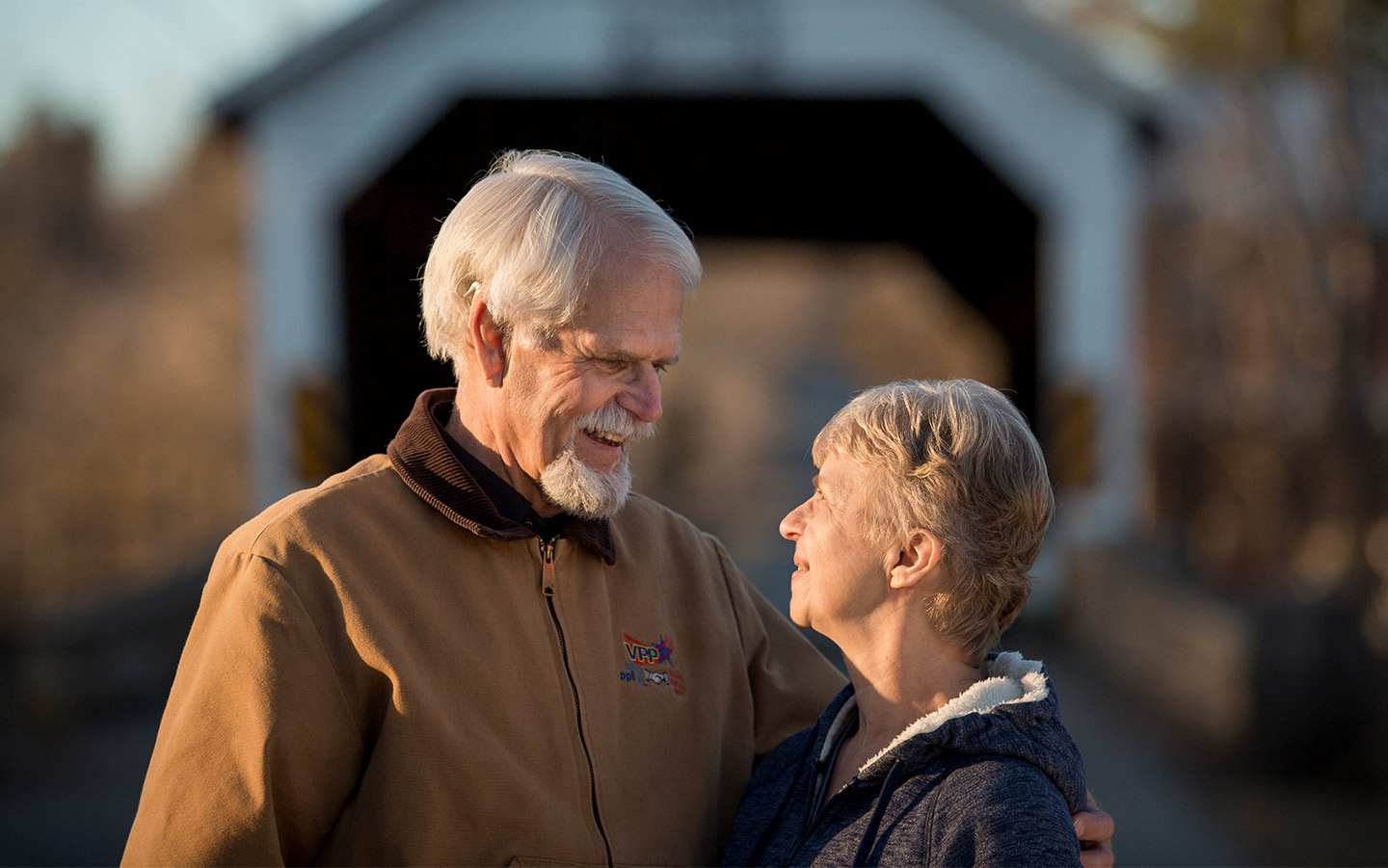 Cochlear implant recipient Kenny smiles at his wife