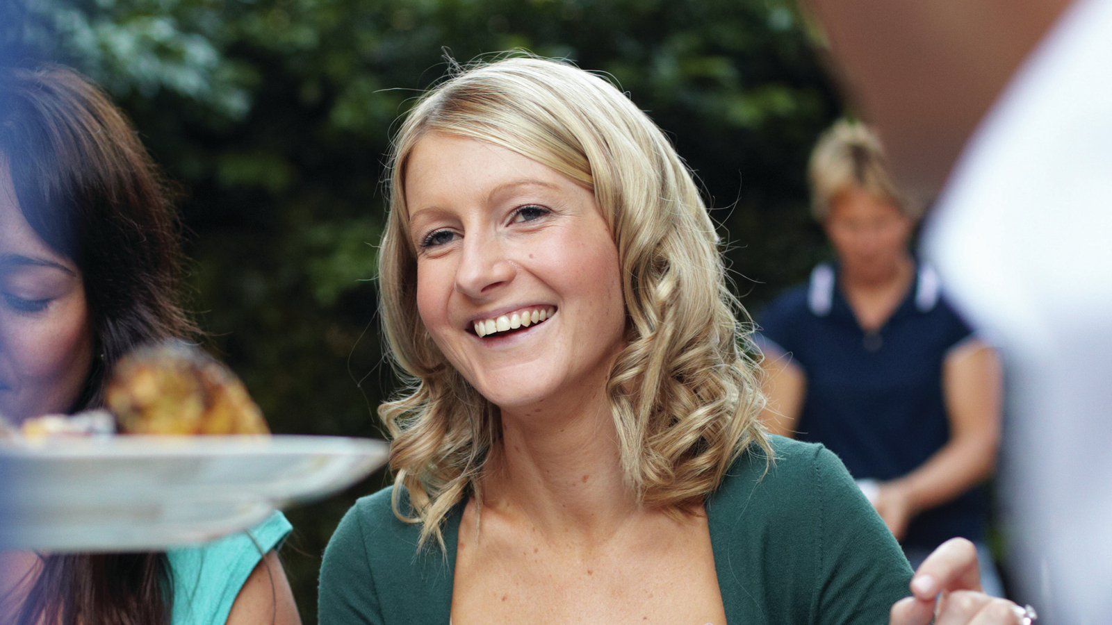 Holly, an Australian Cochlear implant recipient, smiles at a gathering