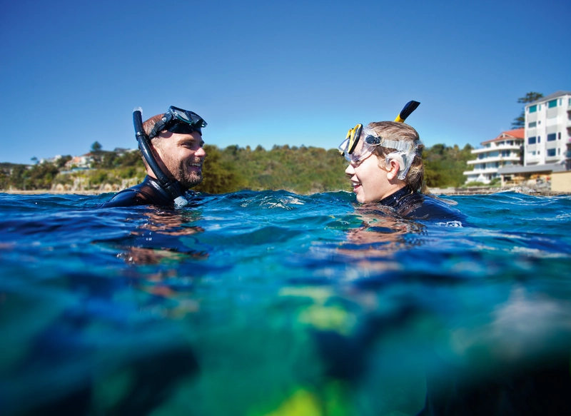 Een man gebruikt zijn waterbestendige accessoire voor Nucleus cochleaire implantaten en het is waterdicht in het water om te snorkelen