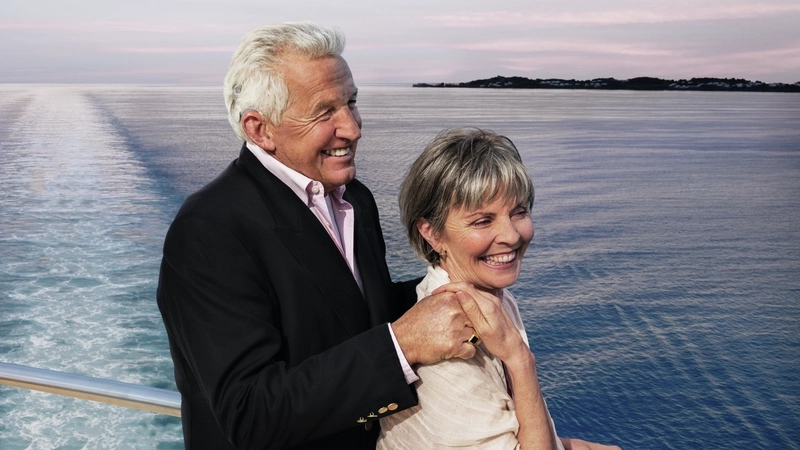 Older couple smiling together on an ocean cruise.