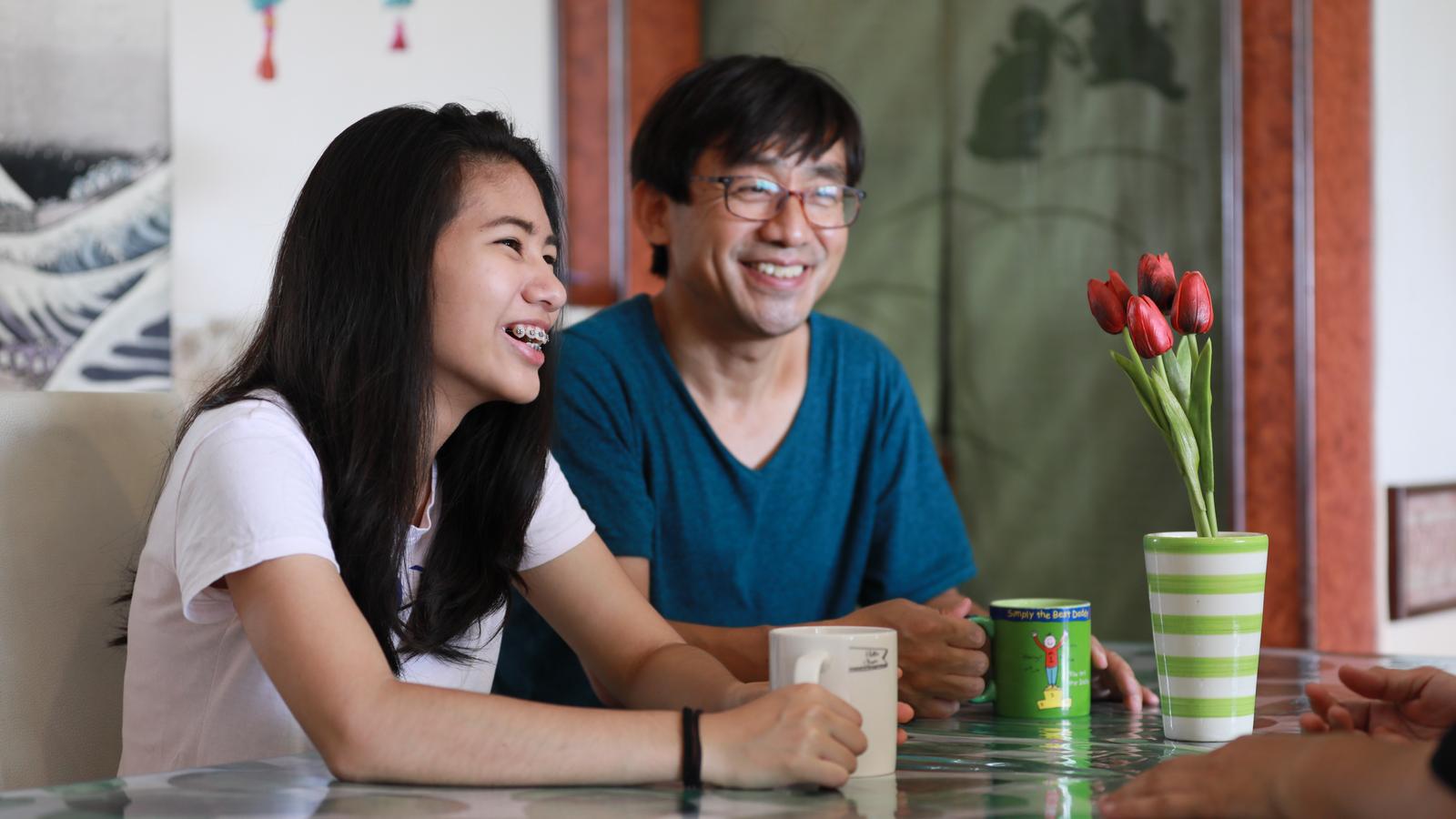 Holly, an Australian Cochlear implant recipient, smiles at a gathering