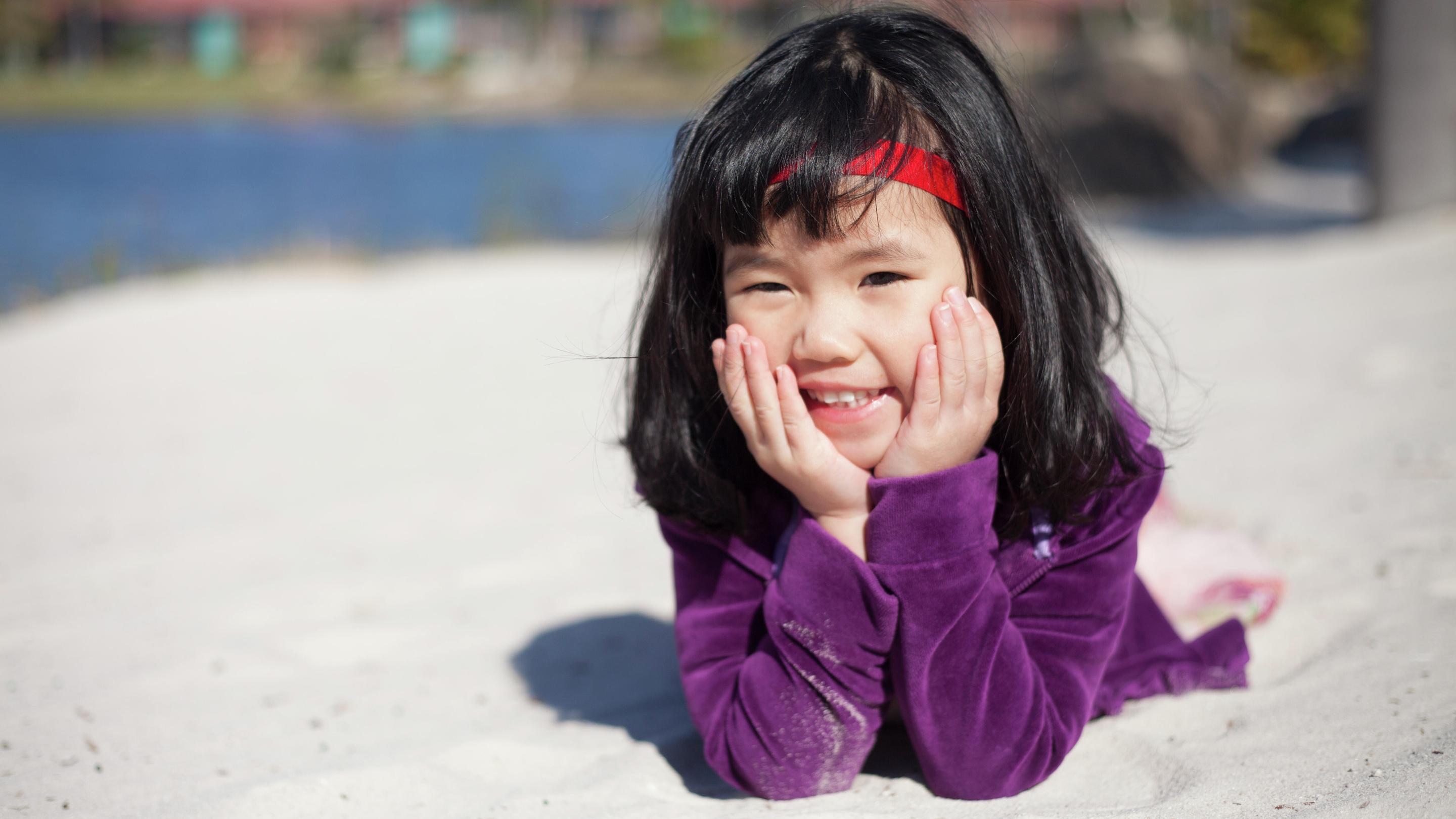 Child wearing Baha SoftBand having fun on the beach