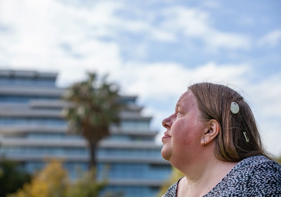 A woman wearing an Cochlear Osia Sound Processor