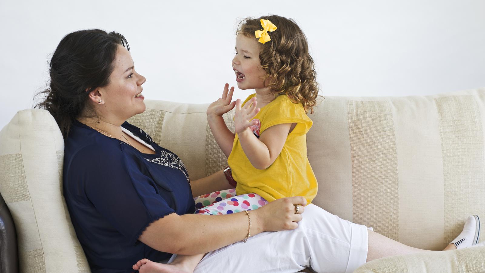 A child candidate implant sits on a woman's lap