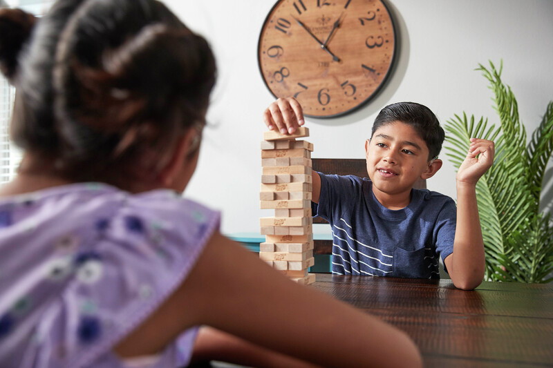 Cochlear recipient Kevin plays a block stacking game with a friend