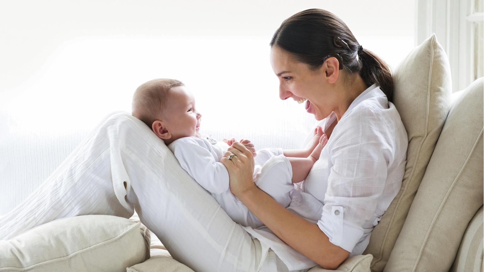 A women and a baby smile at each other