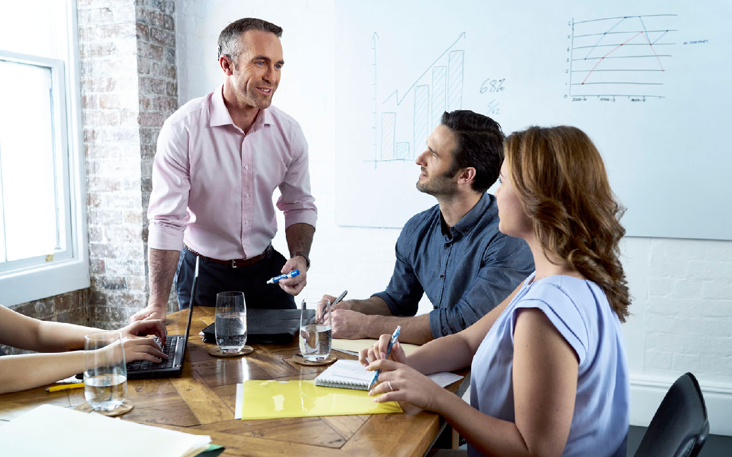 People listen to a work presentation