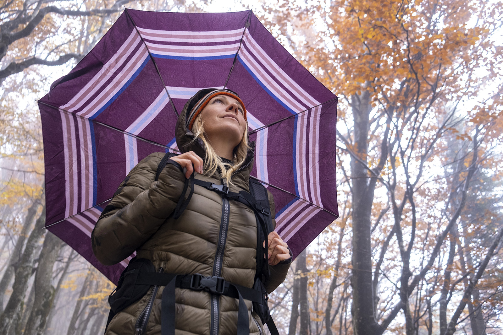 Woman under colourful umbrella