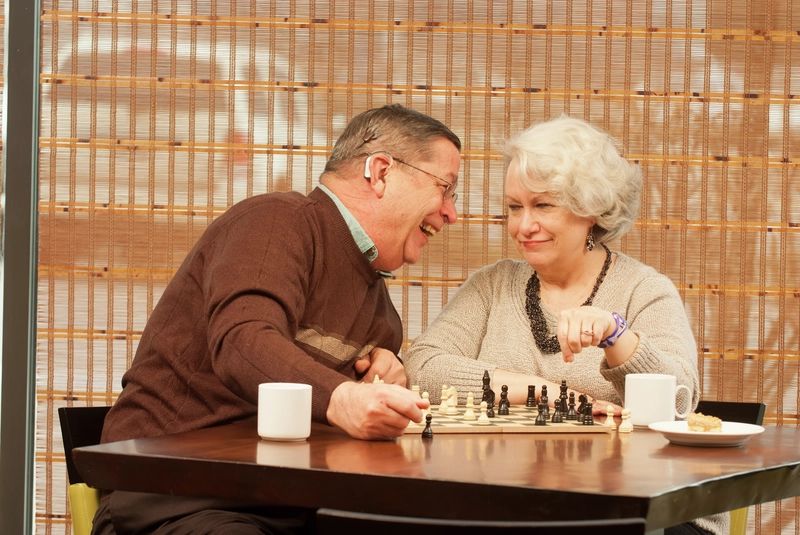 Recipient Bill and wife Pam having fun playing chess game