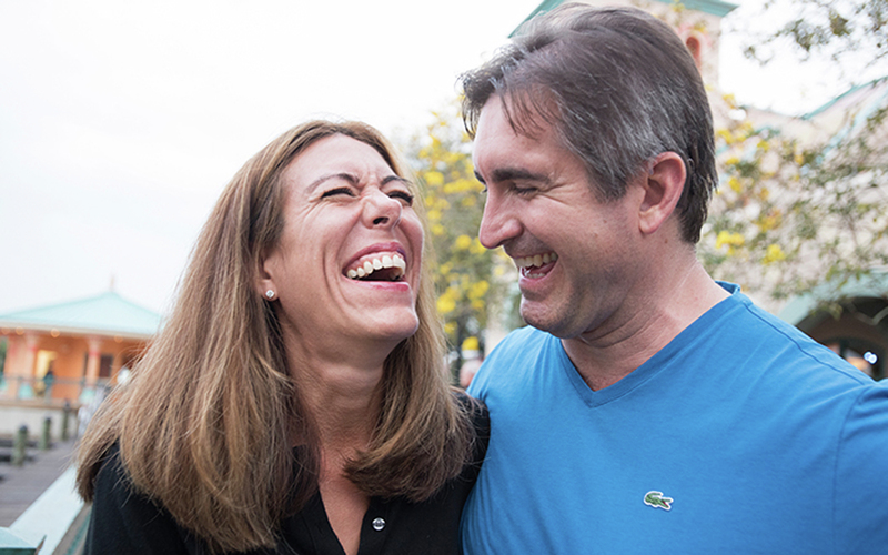 Husband and wife laughing together