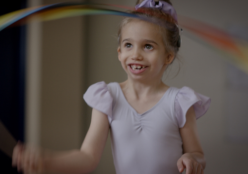 A child wearing a Cochlear Osia System