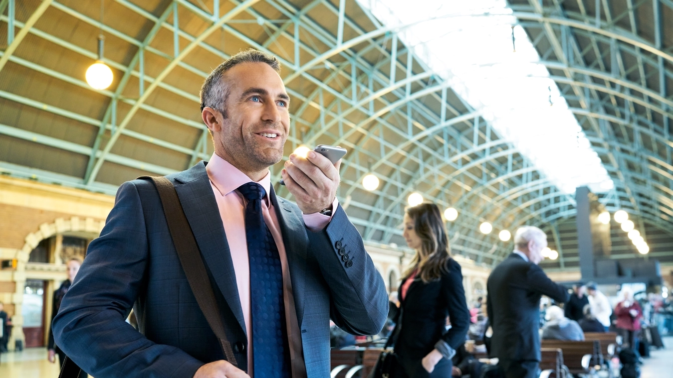 A man wearing an implant chats on a smartphone