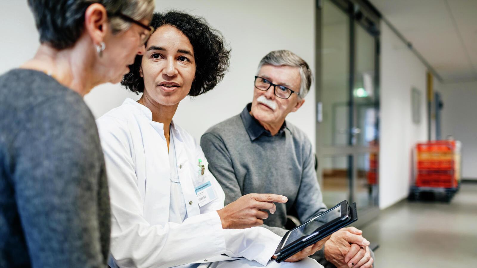 An audiologist conducts a hearing test with a patient