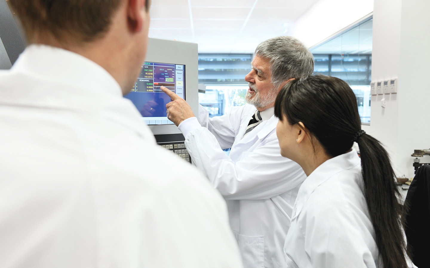 Jim Patrick in discussion with two other scientist