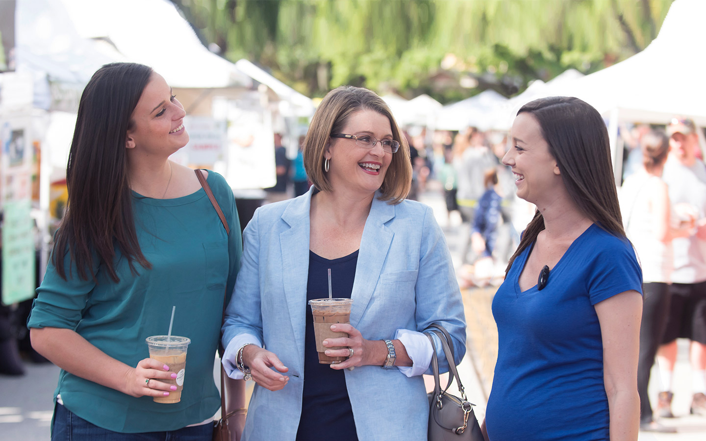 A Cochlear recipient walks with her two adult daughters