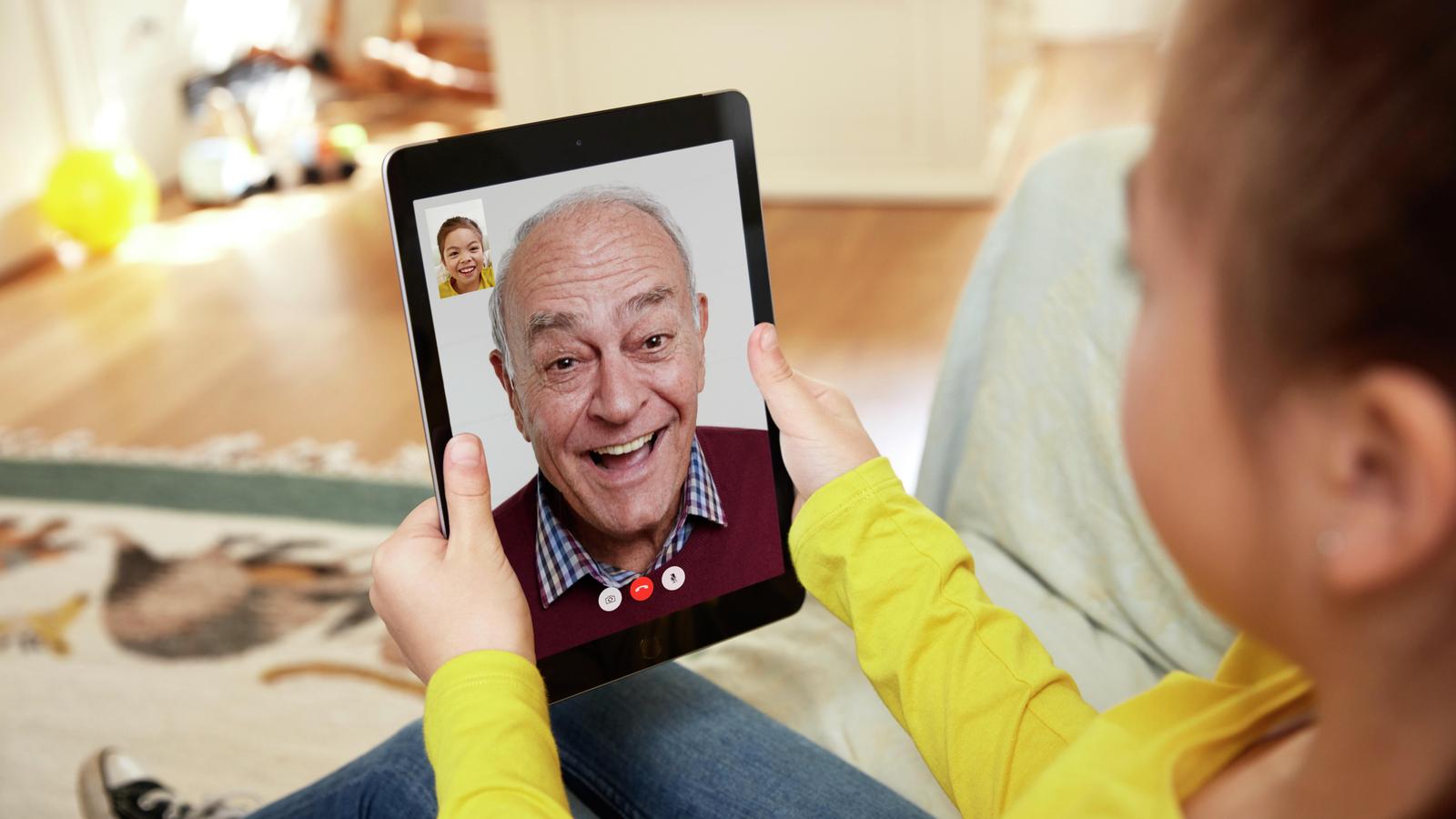 A man appear on an iPad chat with his granddaughter 