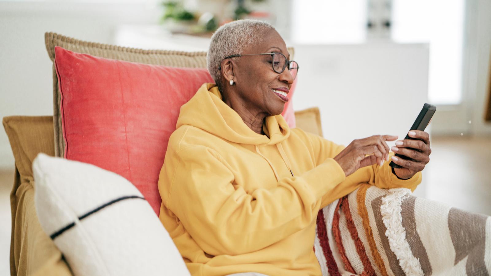 Woman sitting in a chair and looking at her phone