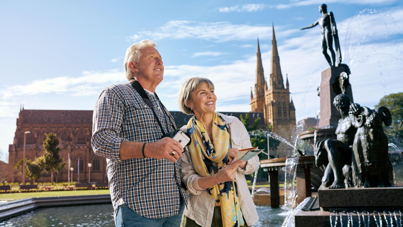 Couple touring London holding an iPhone to navigate