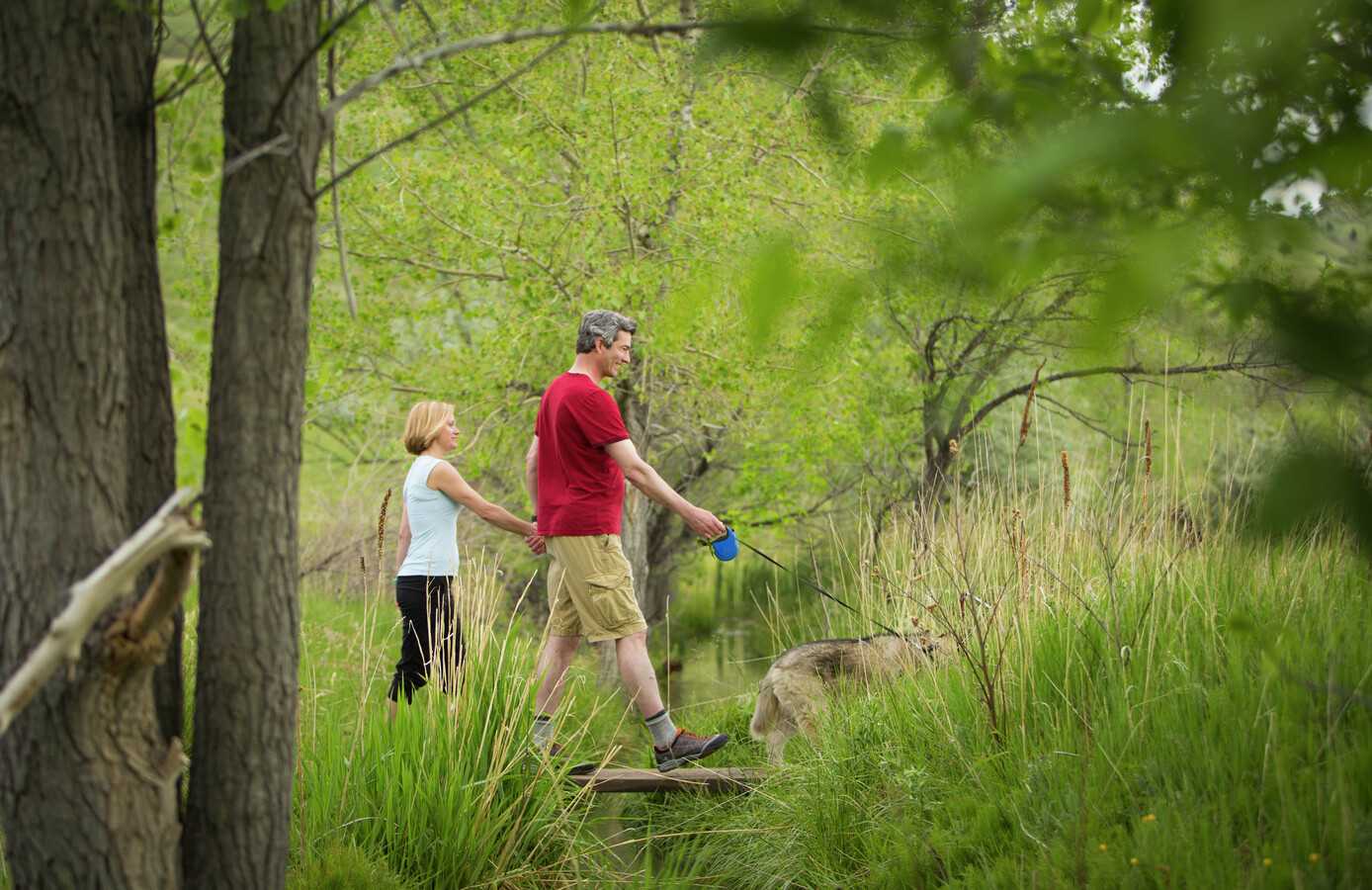 Recipient Mathias walks with his wife and dog